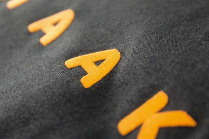Close-up of a textured surface with yellow 'A' and 'K' letters.