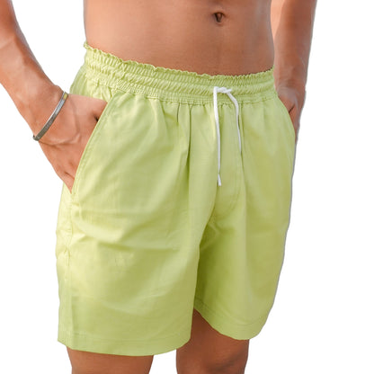 A person wearing green grass-like shorts.